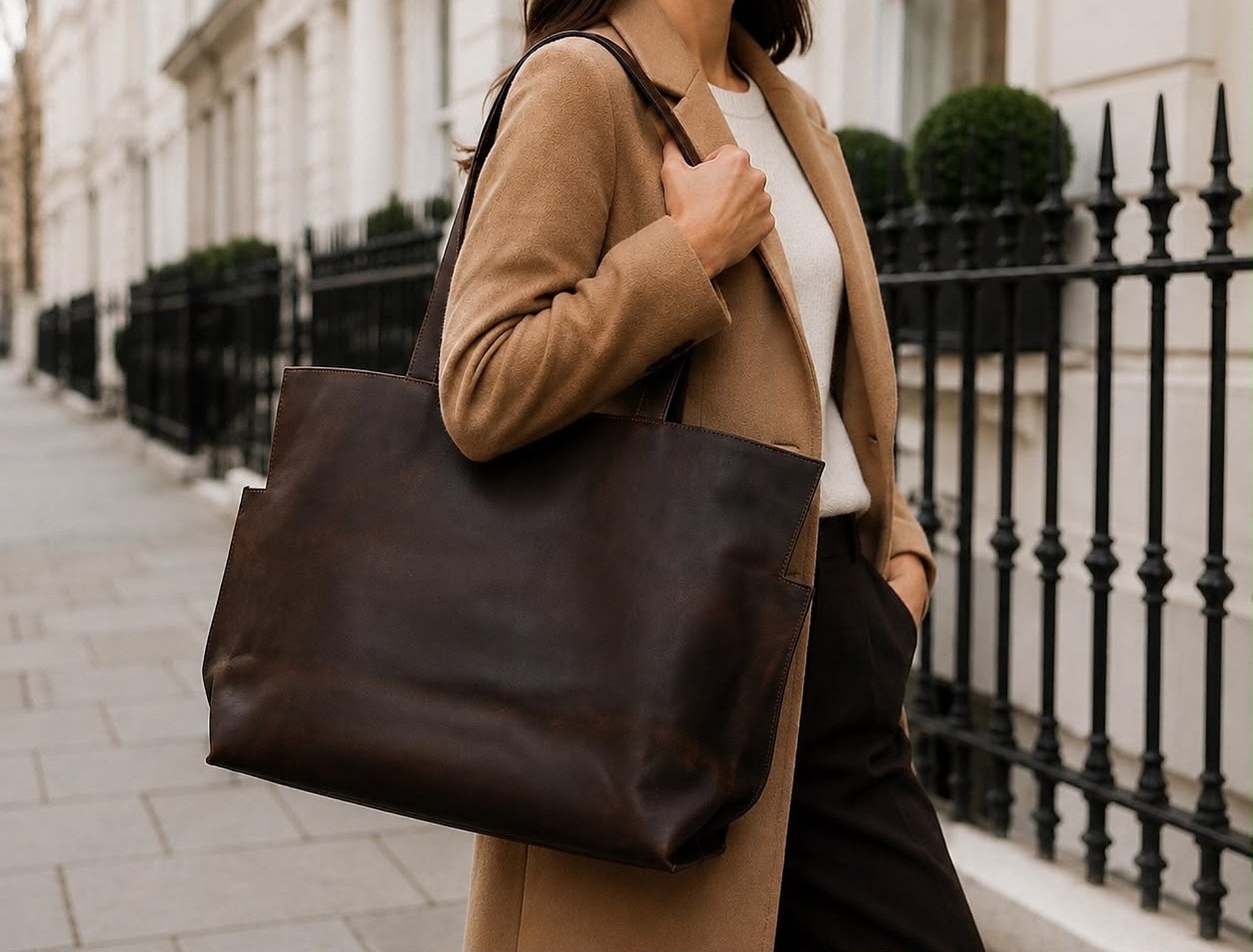 Brown leather tote bag carried over the shoulder on a London street
